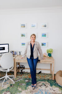 Female business owner posing confidently in a home office during a personal branding photoshoot